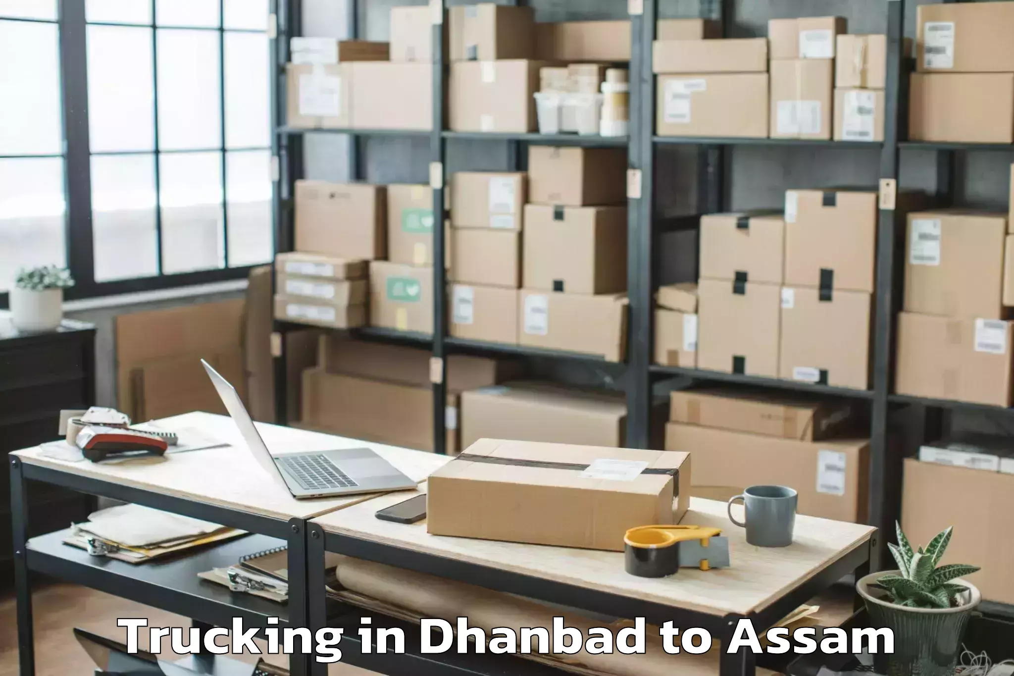 Book Dhanbad to Golokganj Pt Trucking Online